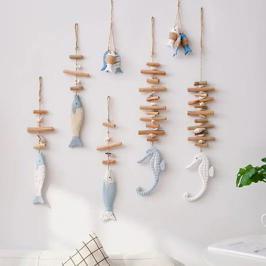 Decorative wall hangings with fish and seahorse shapes on a light background