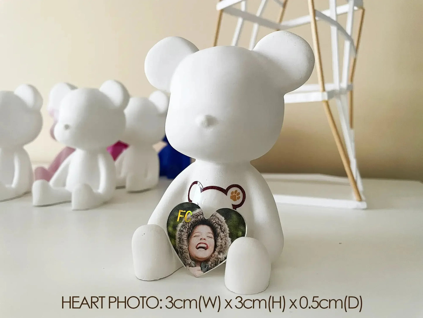White matte ceramic bear figure holding a small heart-shaped photo frame with a smiling woman, displayed as a personalized home decor piece called Batman Bear Figure.