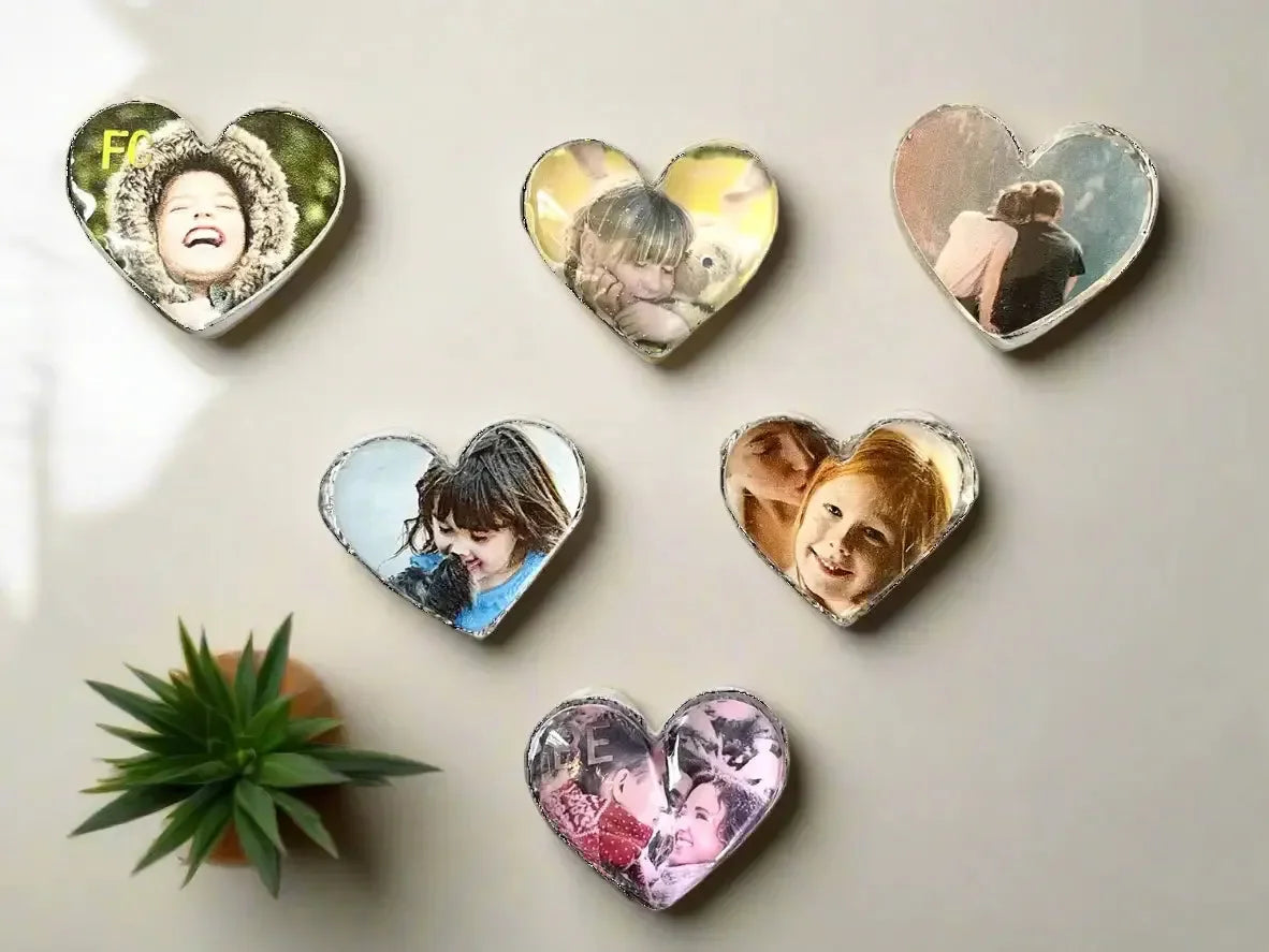 Black Crystal Bear Figure resting on a surface surrounded by heart-shaped personalized photo magnets and a small green succulent plant, showcasing unique and meaningful home decor.