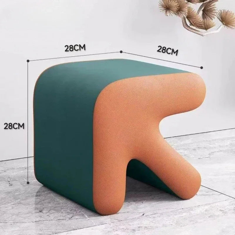 Two-toned stool with measurements on a light wooden floor.
