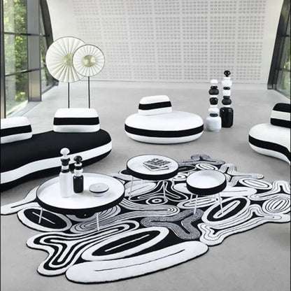 Modern living room with black and white furniture and decor.