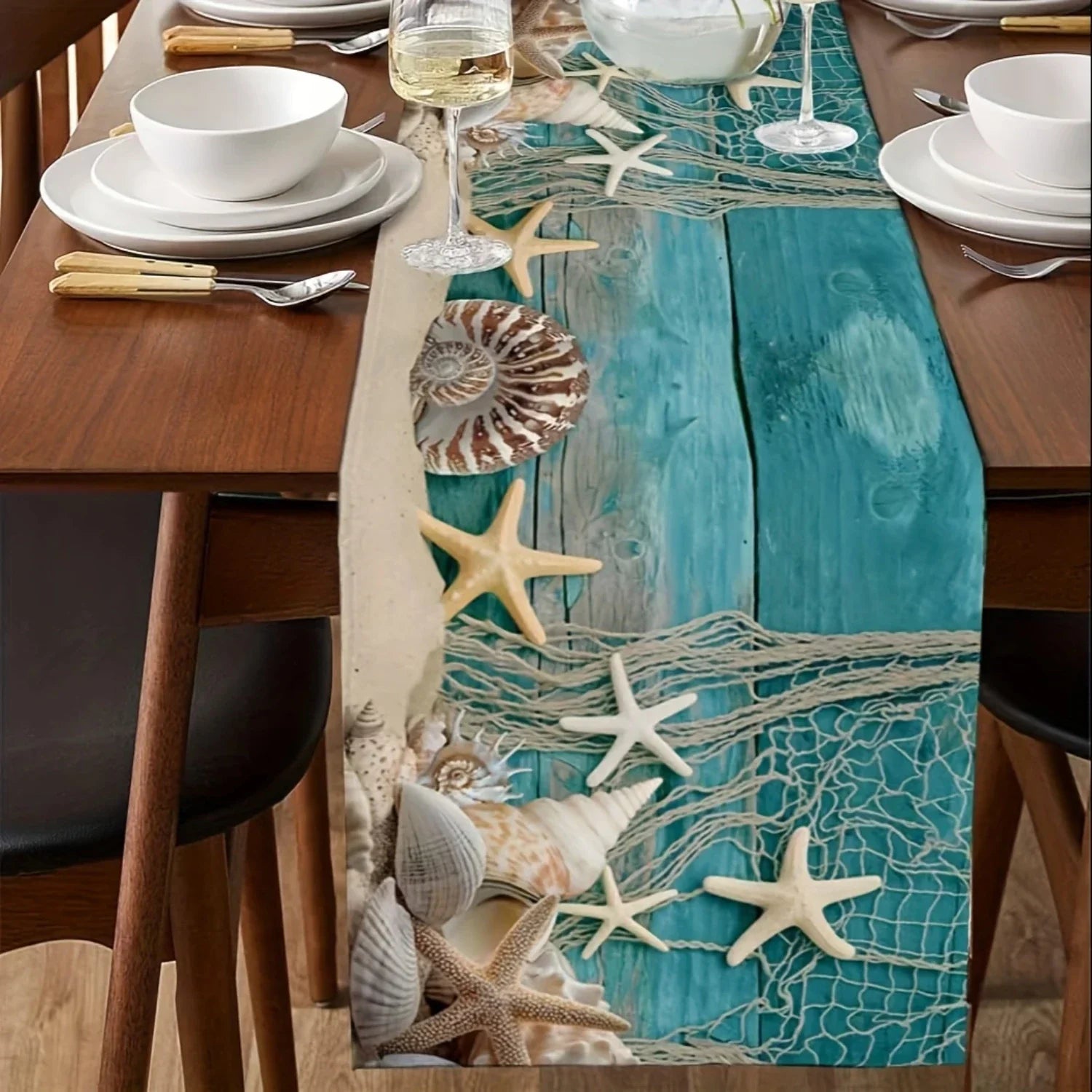 Dining table set with a Coastal table runner featuring starfish and seashells.