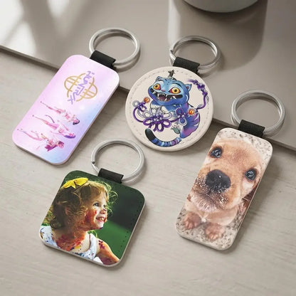 Four keychains with different designs on a light surface
