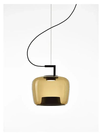 Modern pendant light with amber glass shade and black fixture on a white background