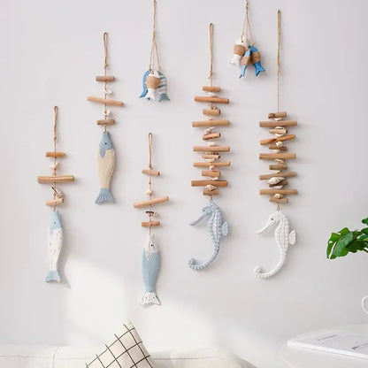 Decorative wall hangings with fish and seahorse shapes on a light background