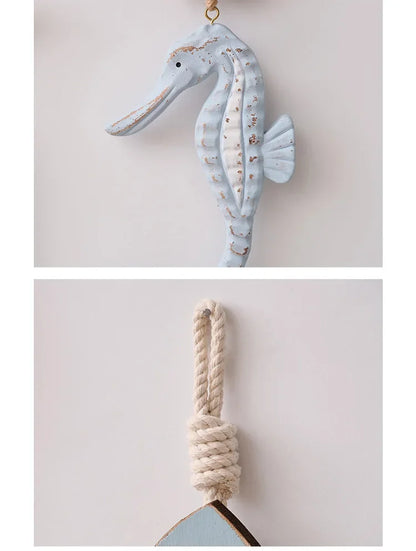 Decorative seahorse hanging on a rope against a light background
