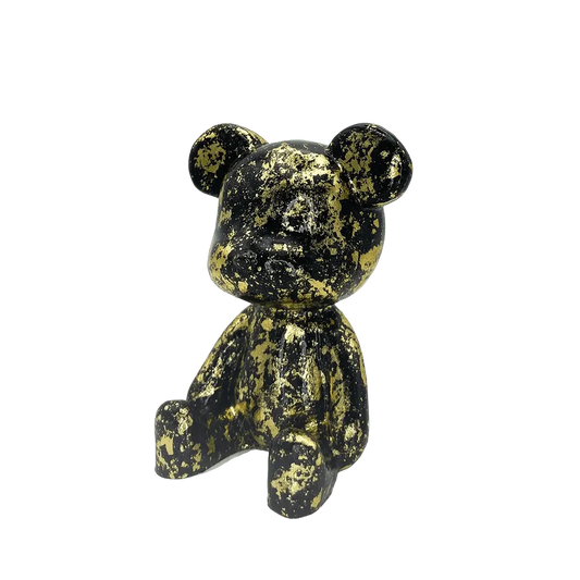 Black and gold speckled bear figurine on a white background