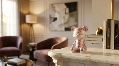 Decorative bear figurine on a marble surface with a stylish interior background