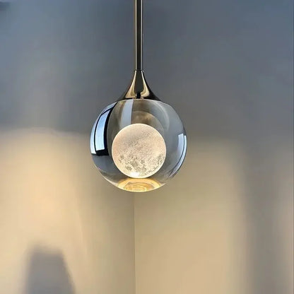 Modern Art Moon Pendant with a glass shade against a neutral background
