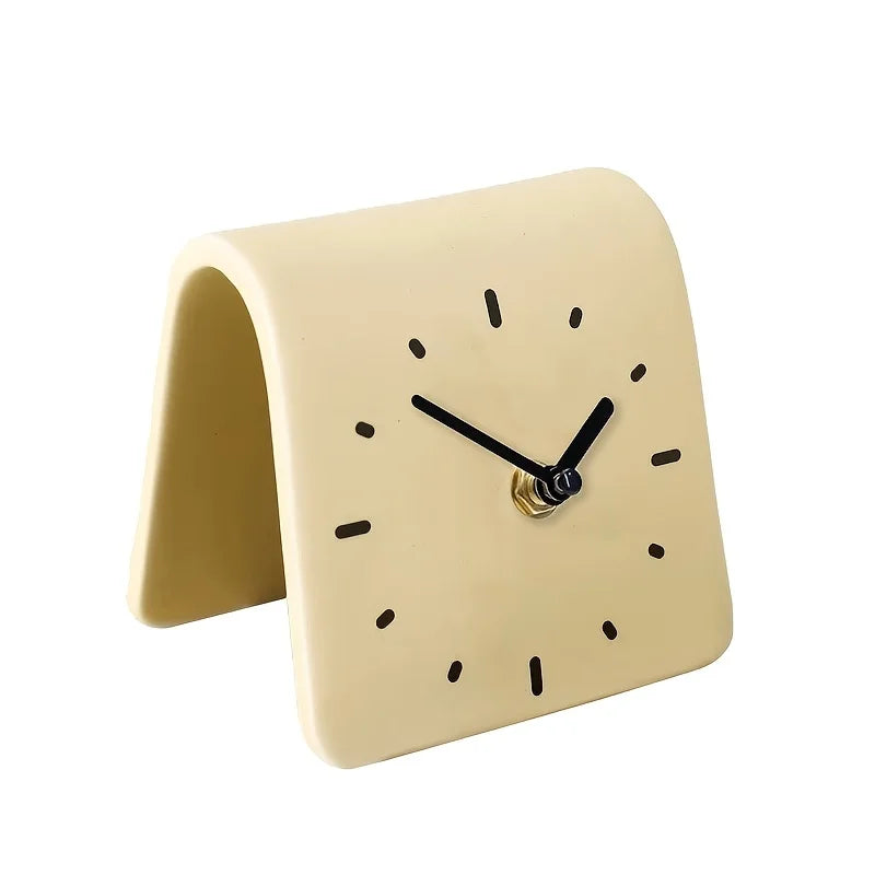 Beige clock with black hands on a white background